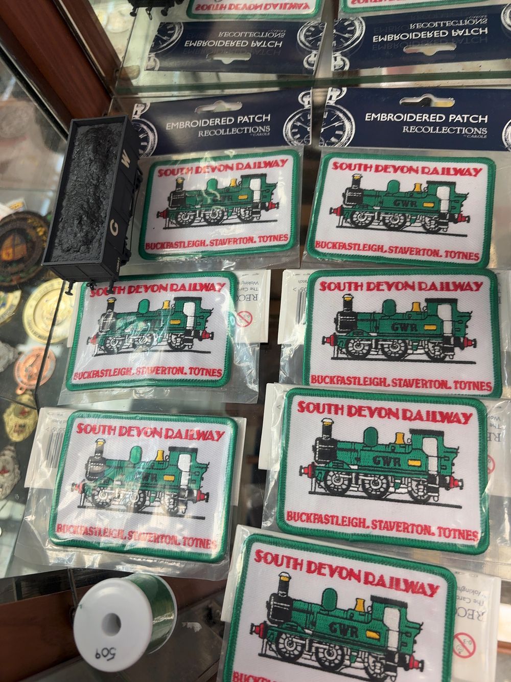 Lot 317: Seven South Devon Railway Souvenir Embroidered Patches and a GWR Model Railway Tender Top