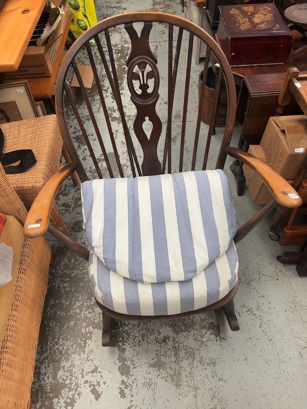 Lot 339: Ercol Spindle Back Rocking Chair with Striped Cushions