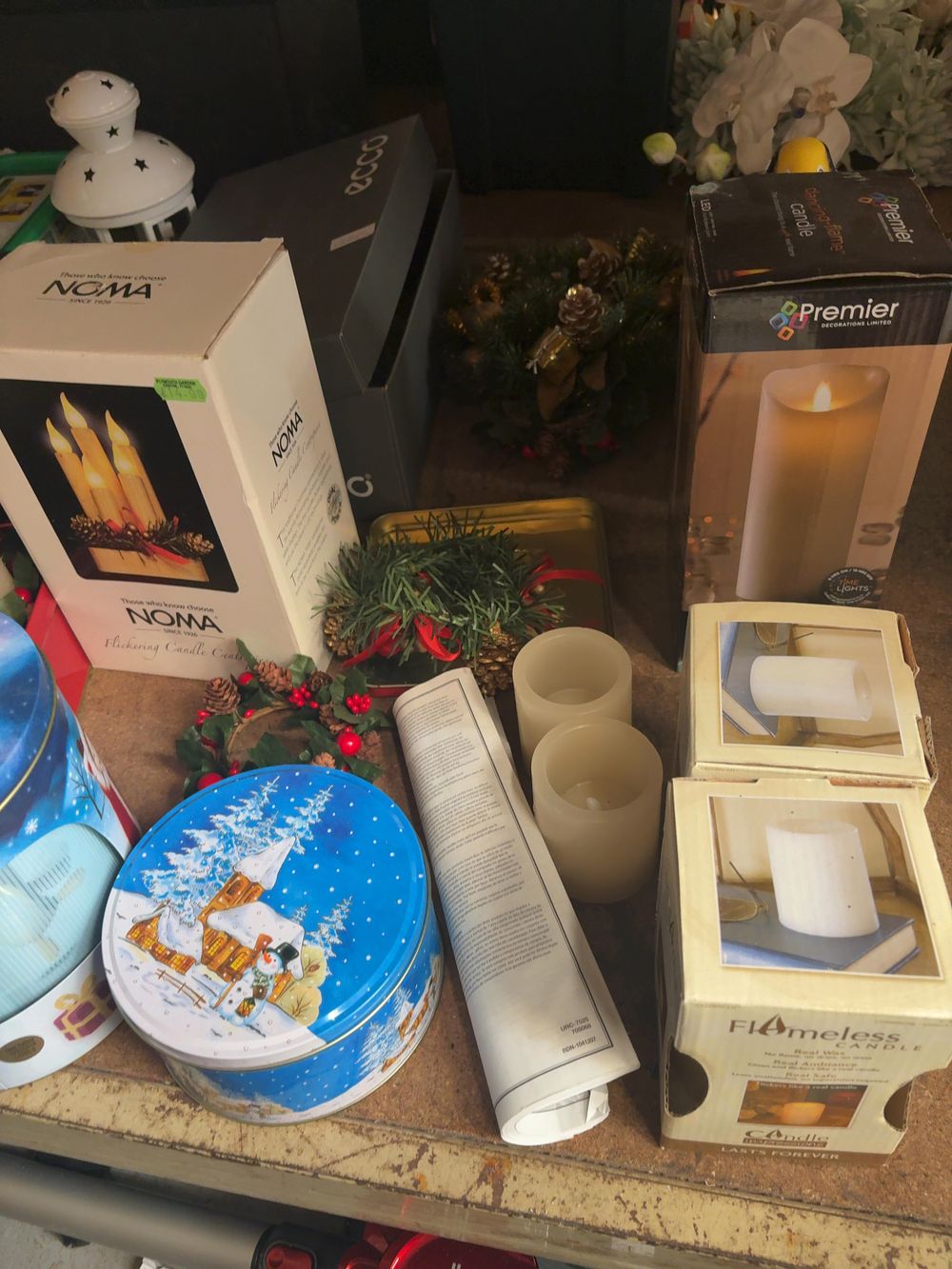 Lot 359: An Assortment of Seasonal LED Flameless Lighting and Decorative Metal Storage Tins