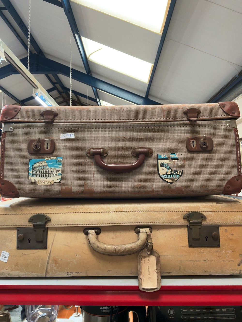 Lot 380: Two mid-20th-century travel suitcases including a fabric example with international decals
