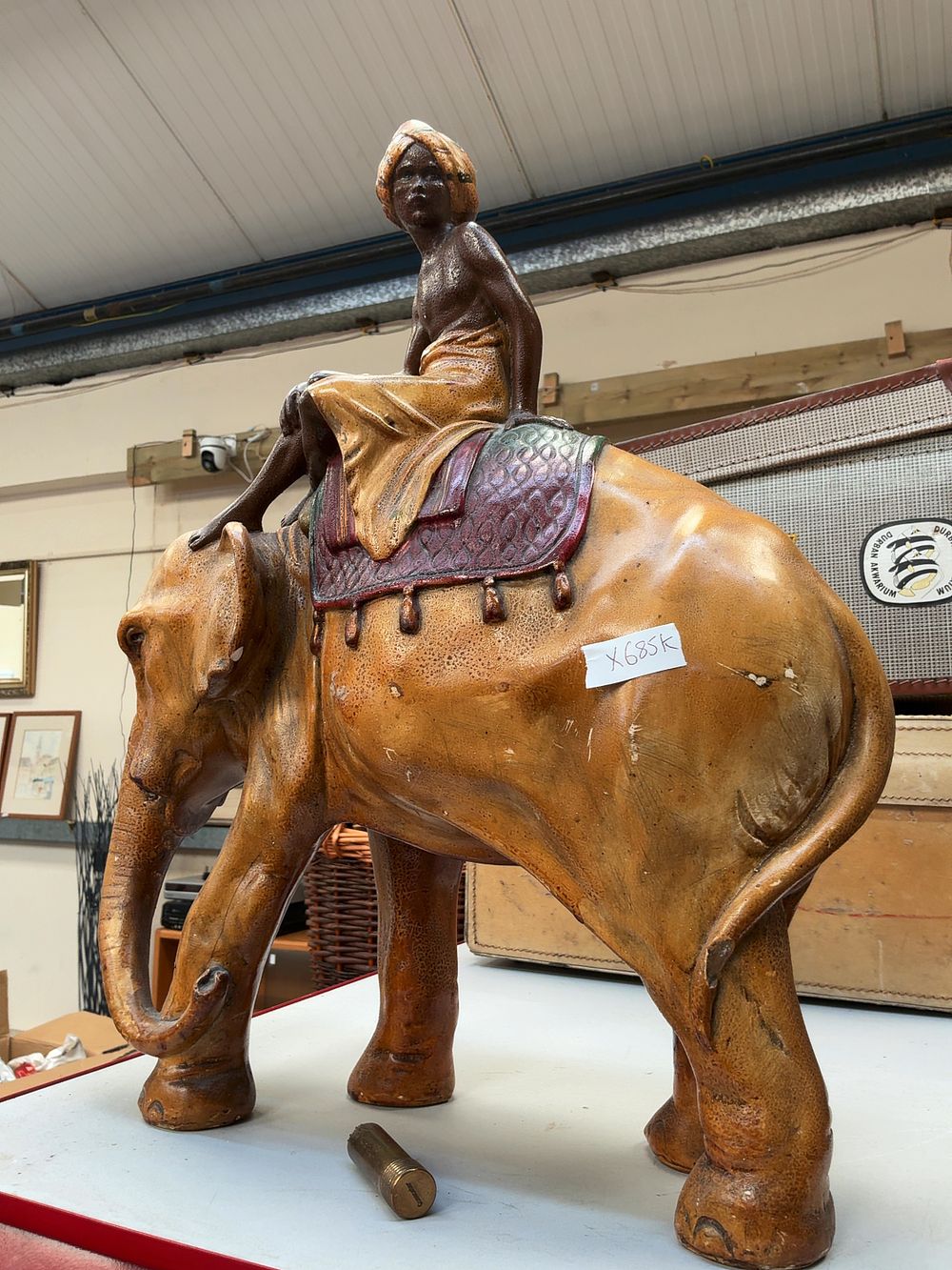 Lot 381: A large Orientalist style composition figure of an elephant and mahout in the manner of Franz Bergman