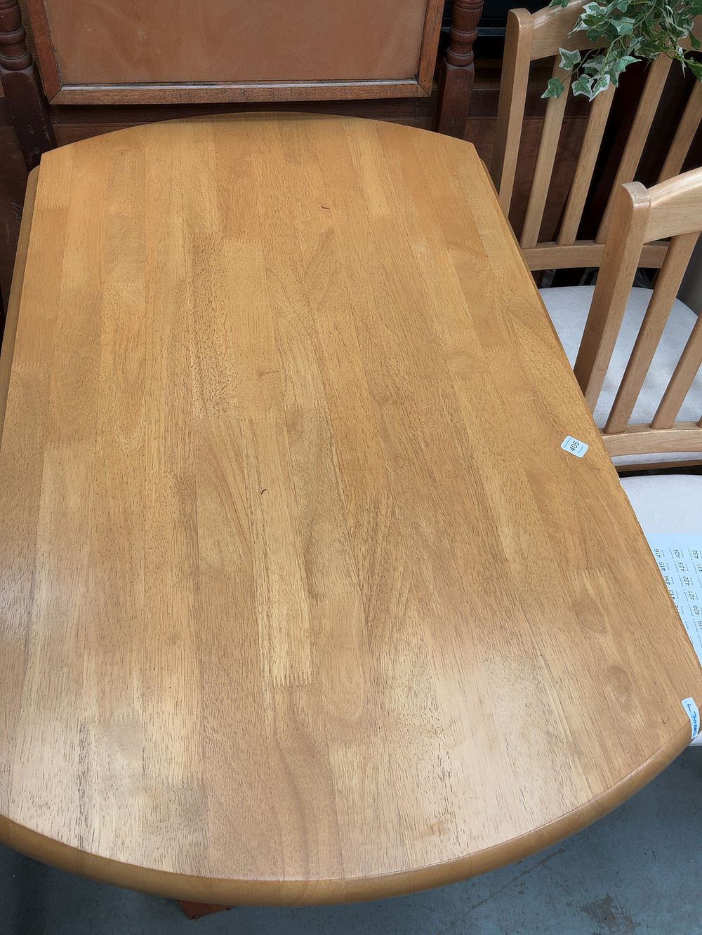 Lot 405: A Contemporary Light Hardwood Stadium-Shaped Dining Table and two chairs.