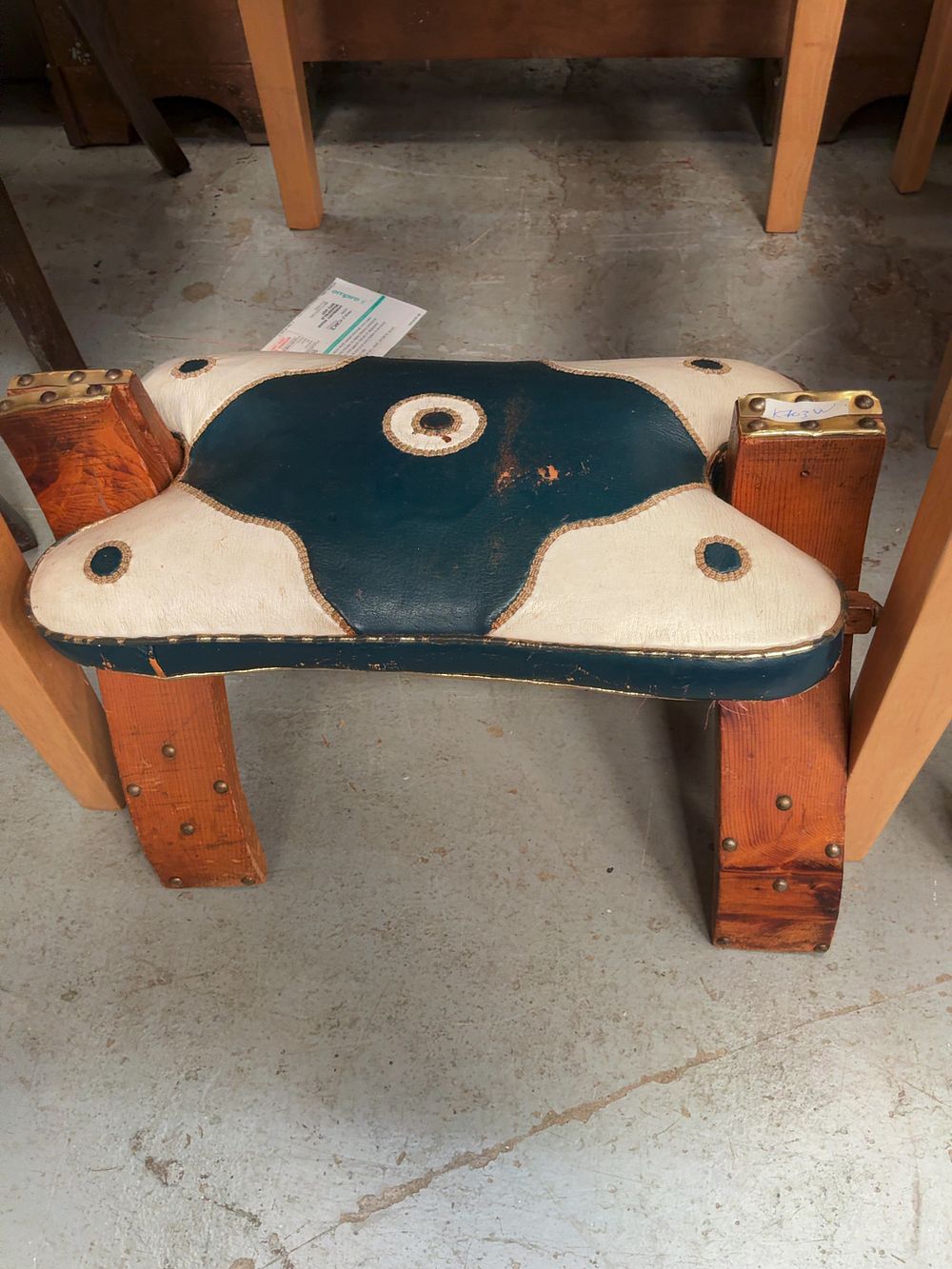 Lot 407: A Mid-20th-Century Moroccan Style Camel Saddle Footstool