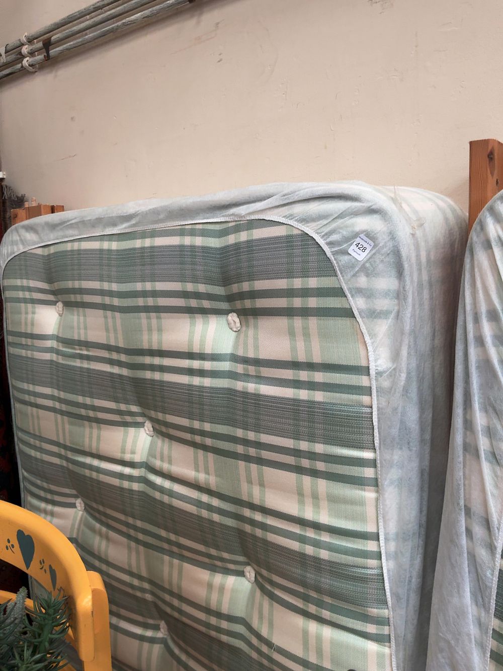 Lot 428: A Contemporary Single Mattress and a Pine Headboard