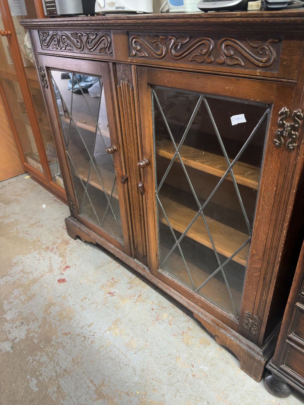 Lot 481: An Old Charm style carved oak and leaded glass display cabinet