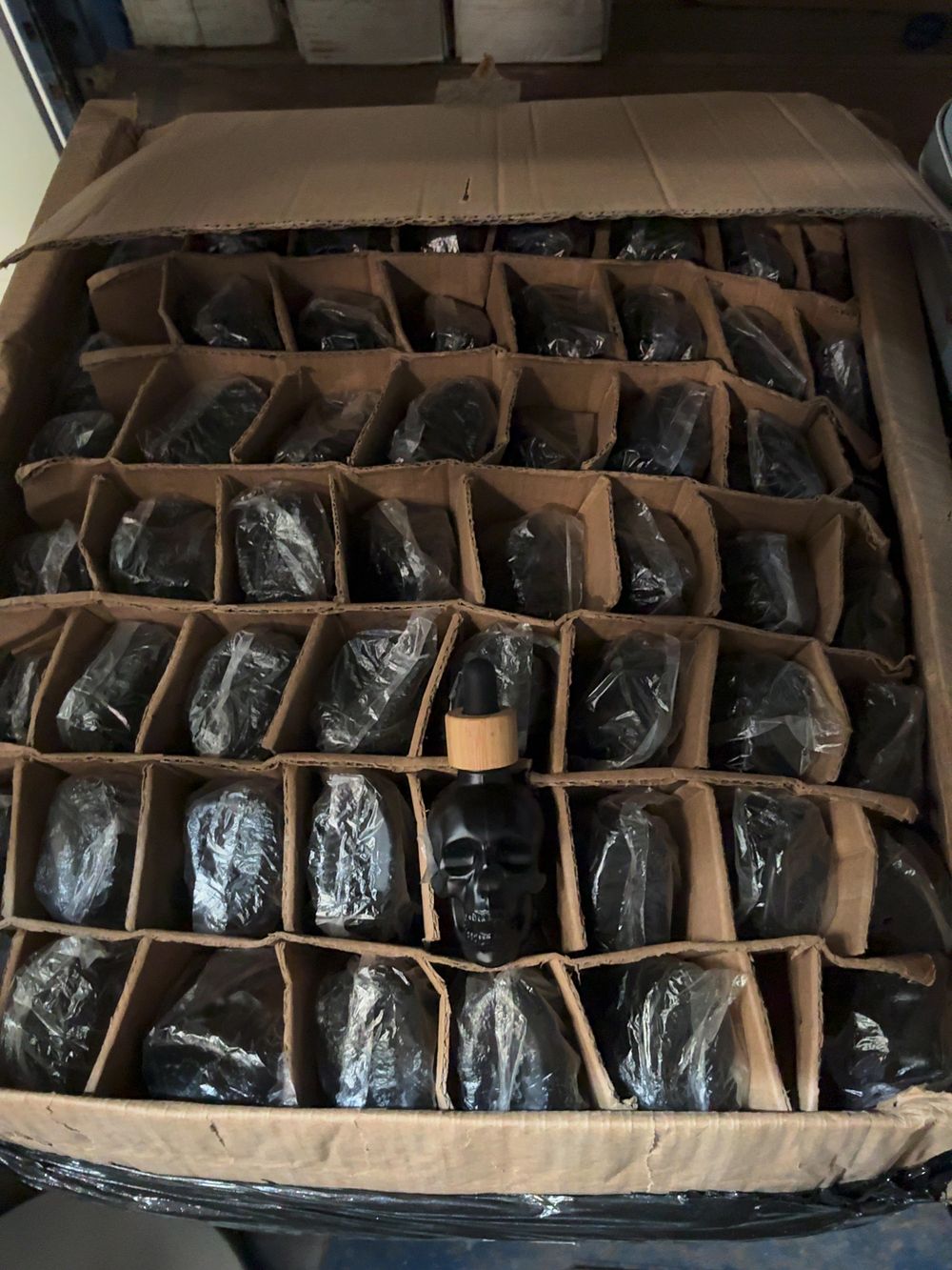 Lot 251: A Wholesale lot of  Matte Black Glass Skull Dropper Bottles