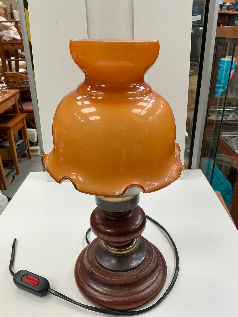 Lot 294: A Vintage Amber Glass Hurricane Style Electric Table Lamp with Turned Wooden Base