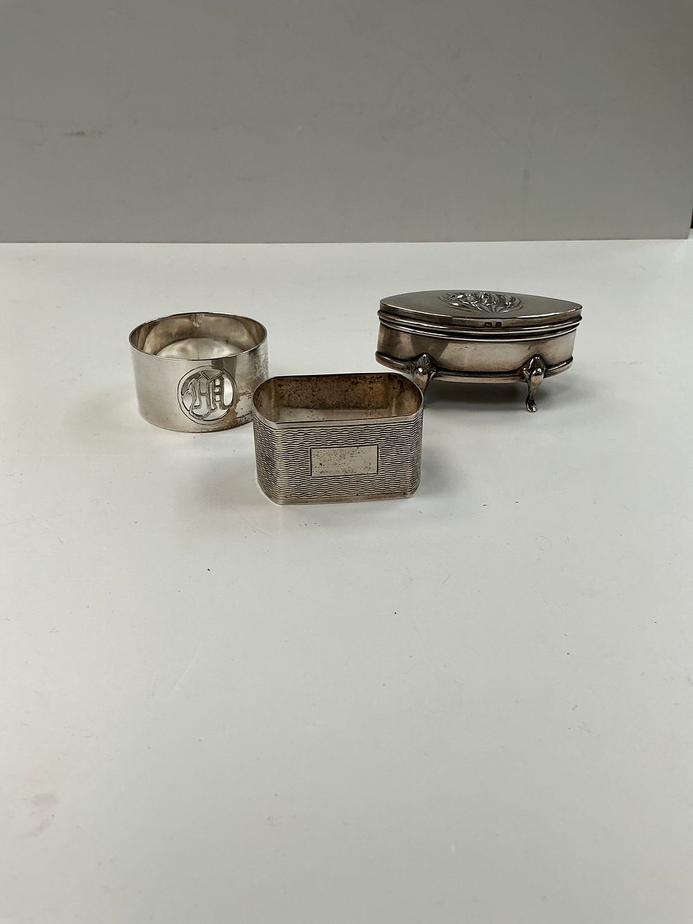 Lot 297: A Trio of British Sterling Silver Items Comprising a Trinket Box and Two Napkin Rings