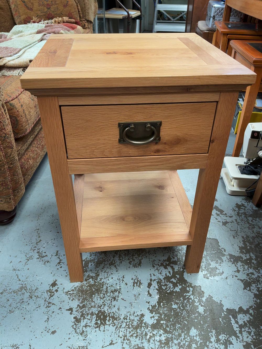 Lot 302: A contemporary light oak side table with drawer and lower shelf