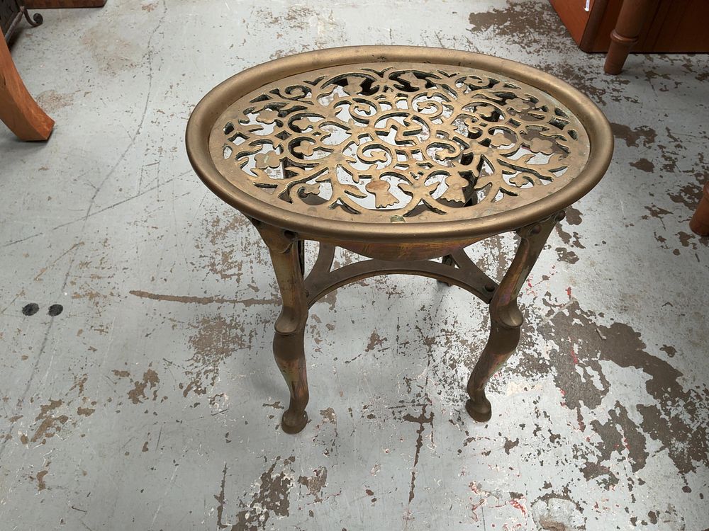 Lot 313: A Celtic Revival cast brass oval hearth stand.