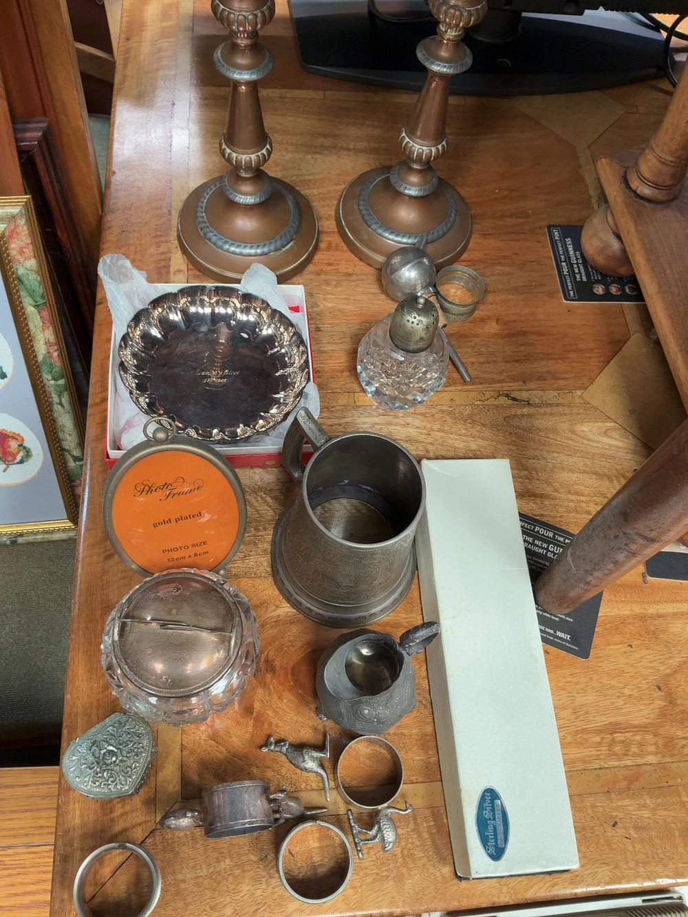 Lot 316: An Assortment of Decorative Metalware including a Sterling Silver Handled Cake Server, Silver Plated Accessories, and a Pair of Mixed Metal Candlesticks