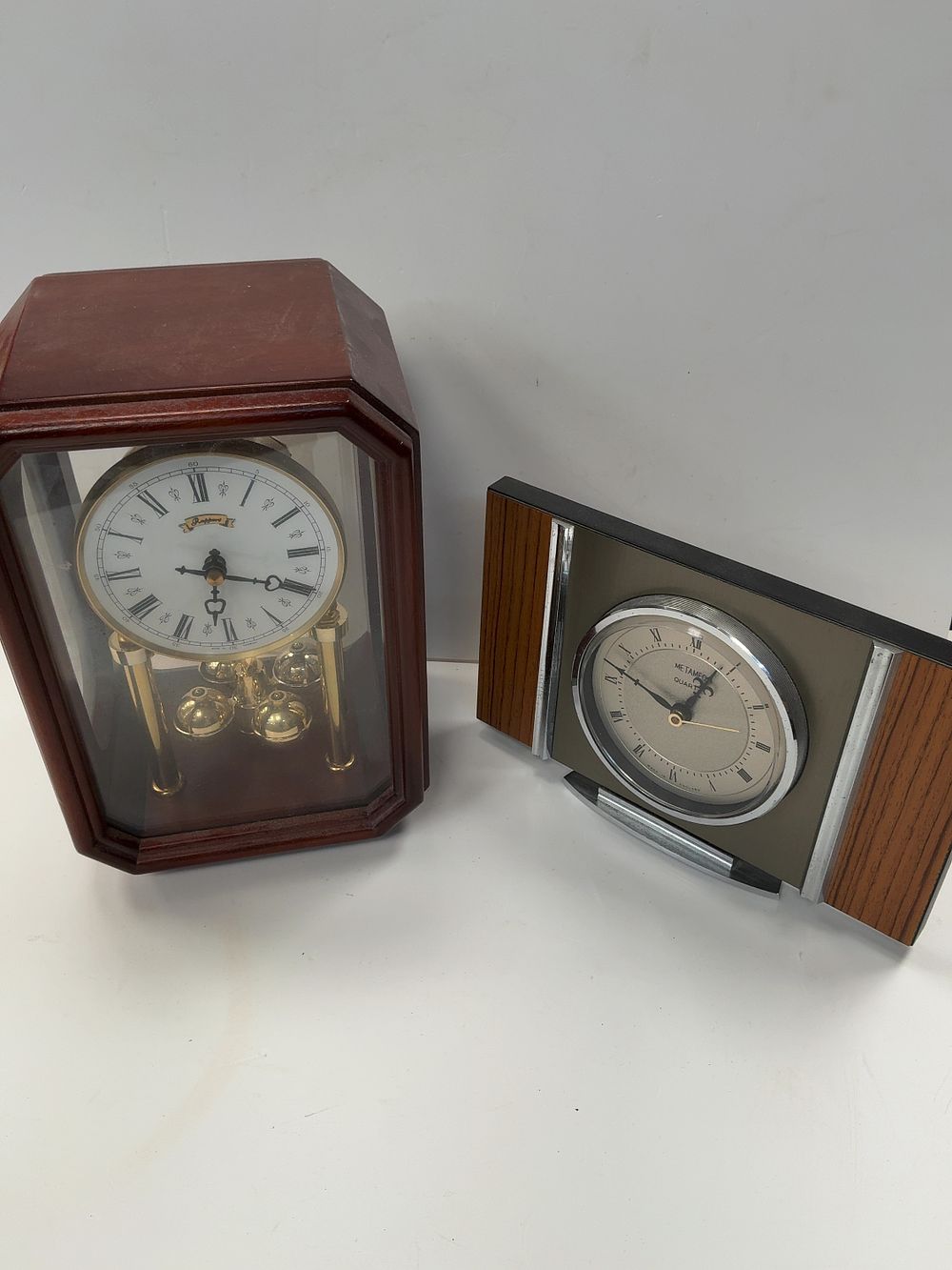 Lot 317: Two Quartz Mantel Clocks Comprising a Rapport Anniversary-Style and a Metamec Modernist Example