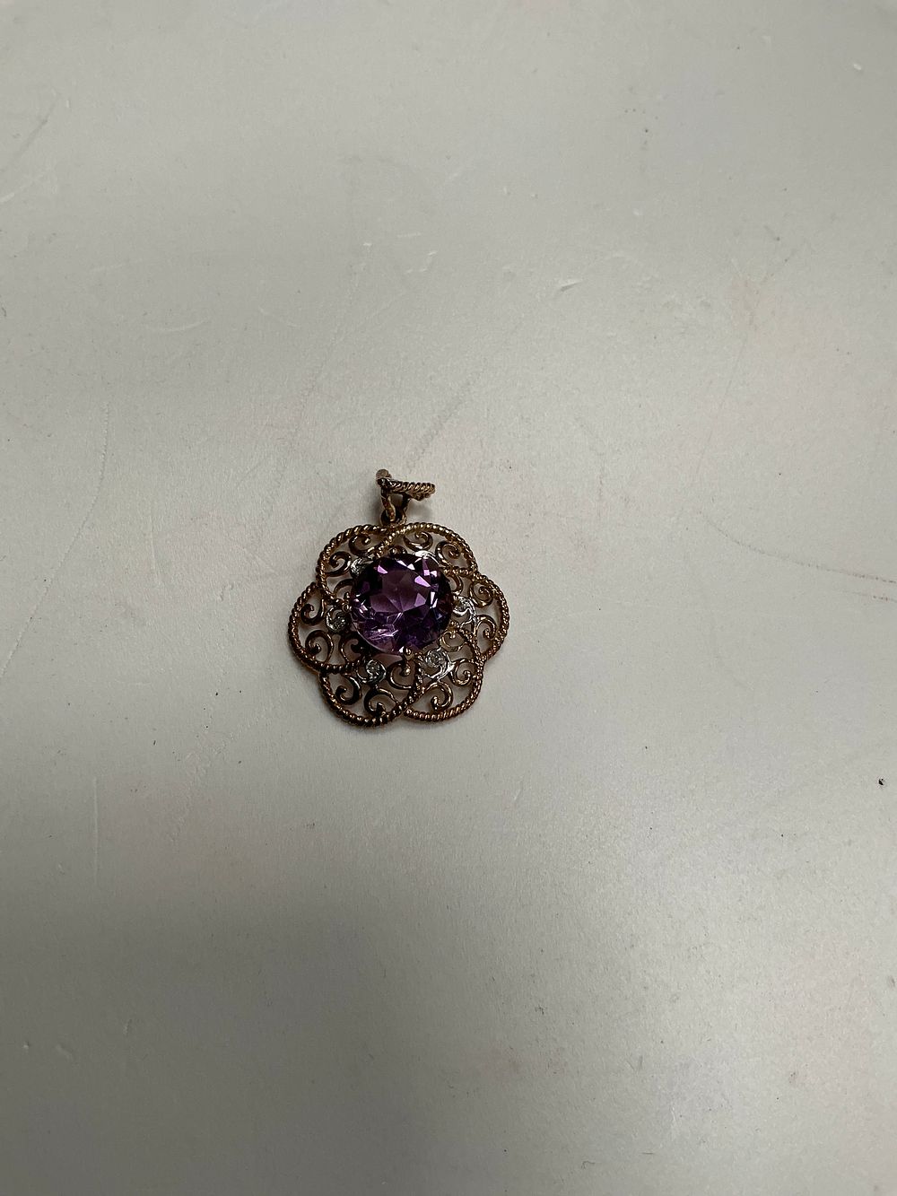 Lot 131: A 9 Carat Gold and Amethyst Filigree Pendant