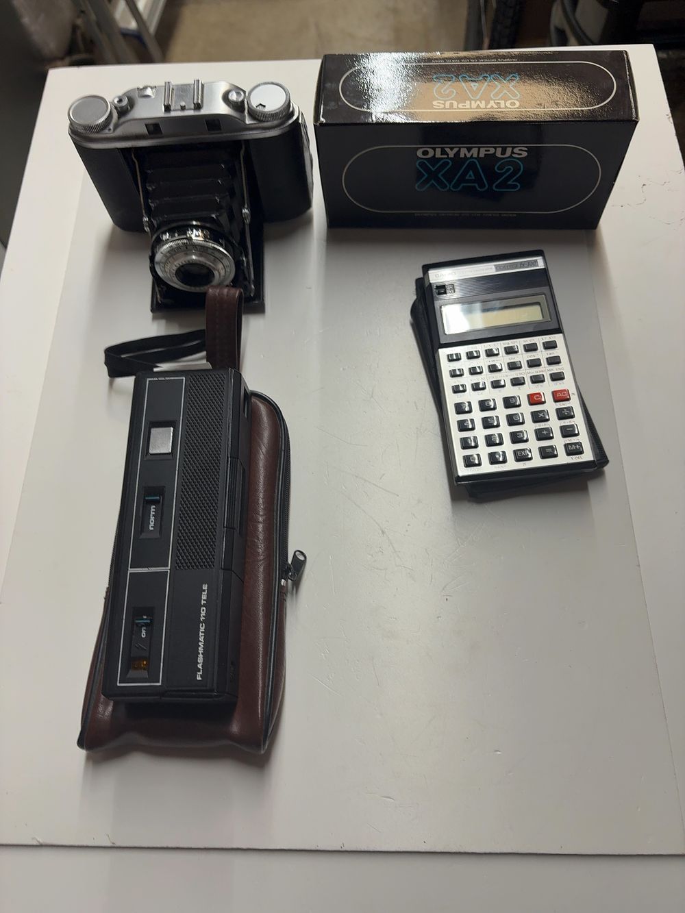 Lot 460: A Collection of Vintage Cameras including Agfa and Olympus Models with a Casio Scientific Calculator