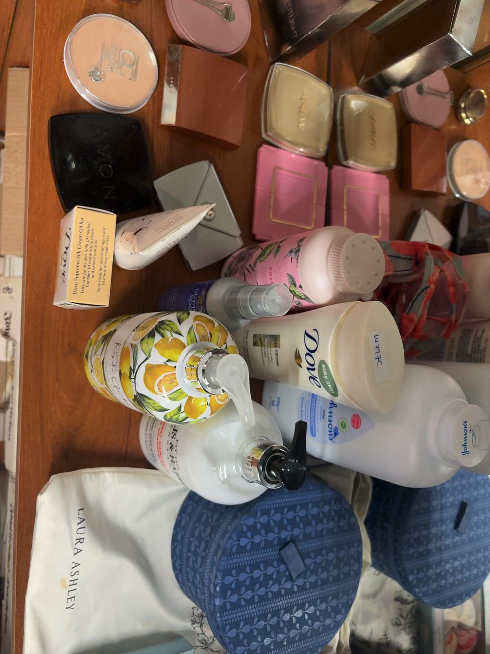 Lot 464: An Assortment of Branded Cosmetics, Toiletries, and Vanity Accessories including Avon, Dove, and Baylis and Harding