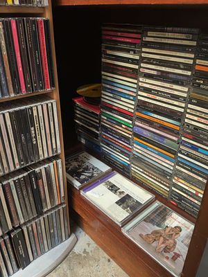 A Large Assortment of Popular Music Compact Discs Including George Michael, Queen, and The Beatles. 