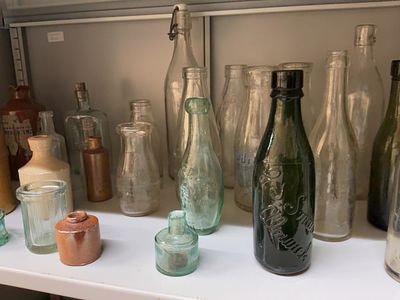 An Assortment of Antique and Vintage British Glass and Stoneware Bottles. A diverse group of 