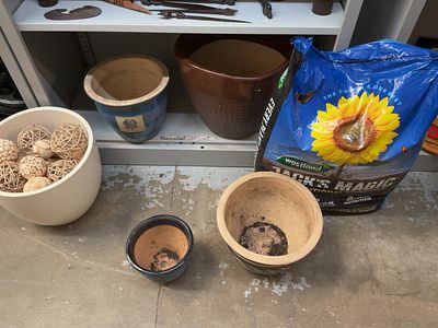 An Assortment of Ceramic Garden Planters, Decorative Spheres, and Compost. This lot comprises an 