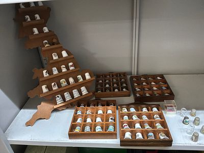 A Collection of Vintage Souvenir Ceramic, Metal, and Glass Thimbles with Wooden Display Cases. An 