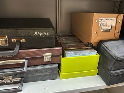 An Assortment of Cassette Tapes and Compact Discs with Multiple Storage Units. An extensive 