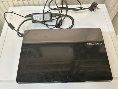 eMachines E440 Laptop Computer with AC Power Adapter. An eMachines E440 laptop computer 