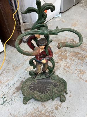 A Late Victorian Style Polychrome Painted Cast Iron Figural Umbrella Stand. A figural cast iron 