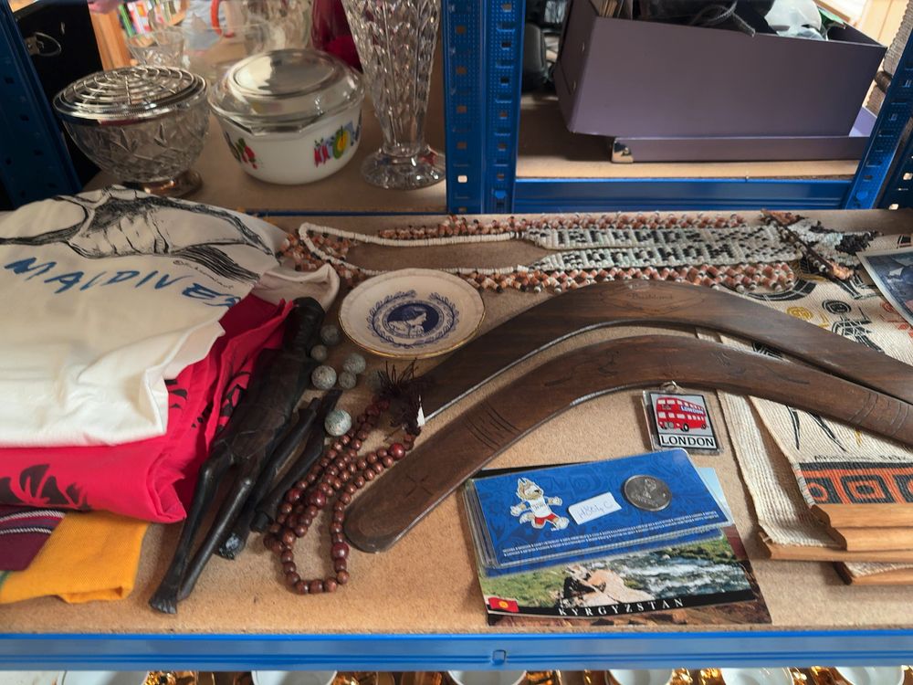 Lot 178: A Collection of Global Travel Souvenirs and Cultural Artifacts Including Australian Boomerangs and Ethnic Textiles