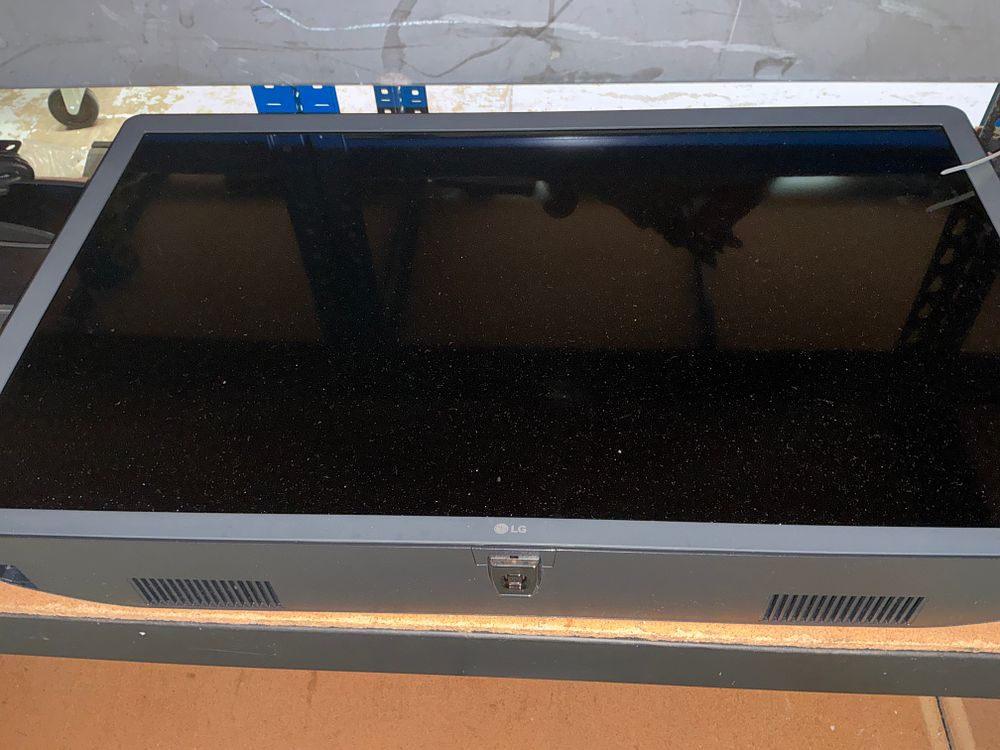 Lot 196: LG Smart Television with Wall Mount and Accessories