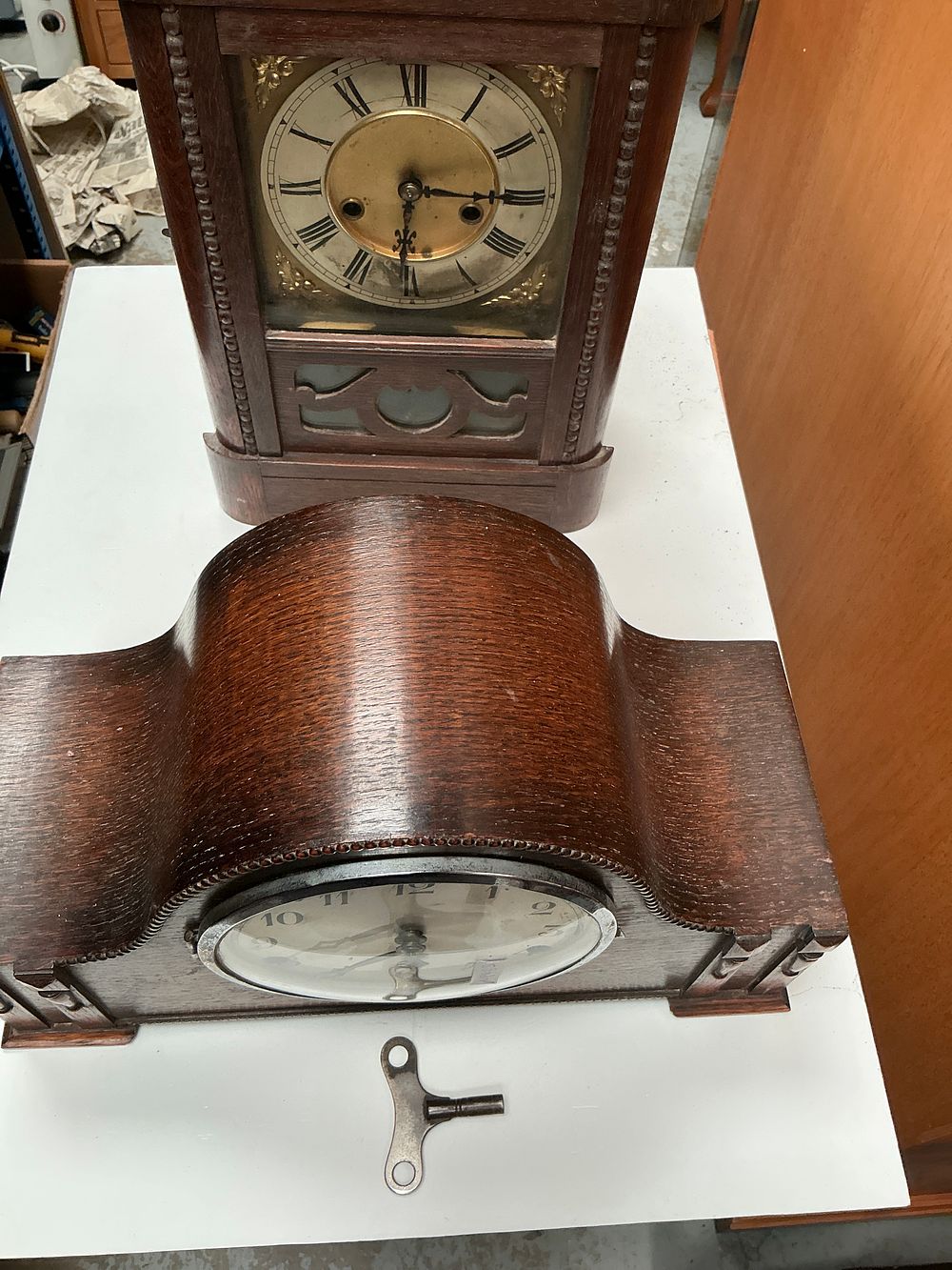 Lot 209: Two early 20th-century wooden mantel clocks including a German bracket clock and a Westminster chime Napoleon hat clock