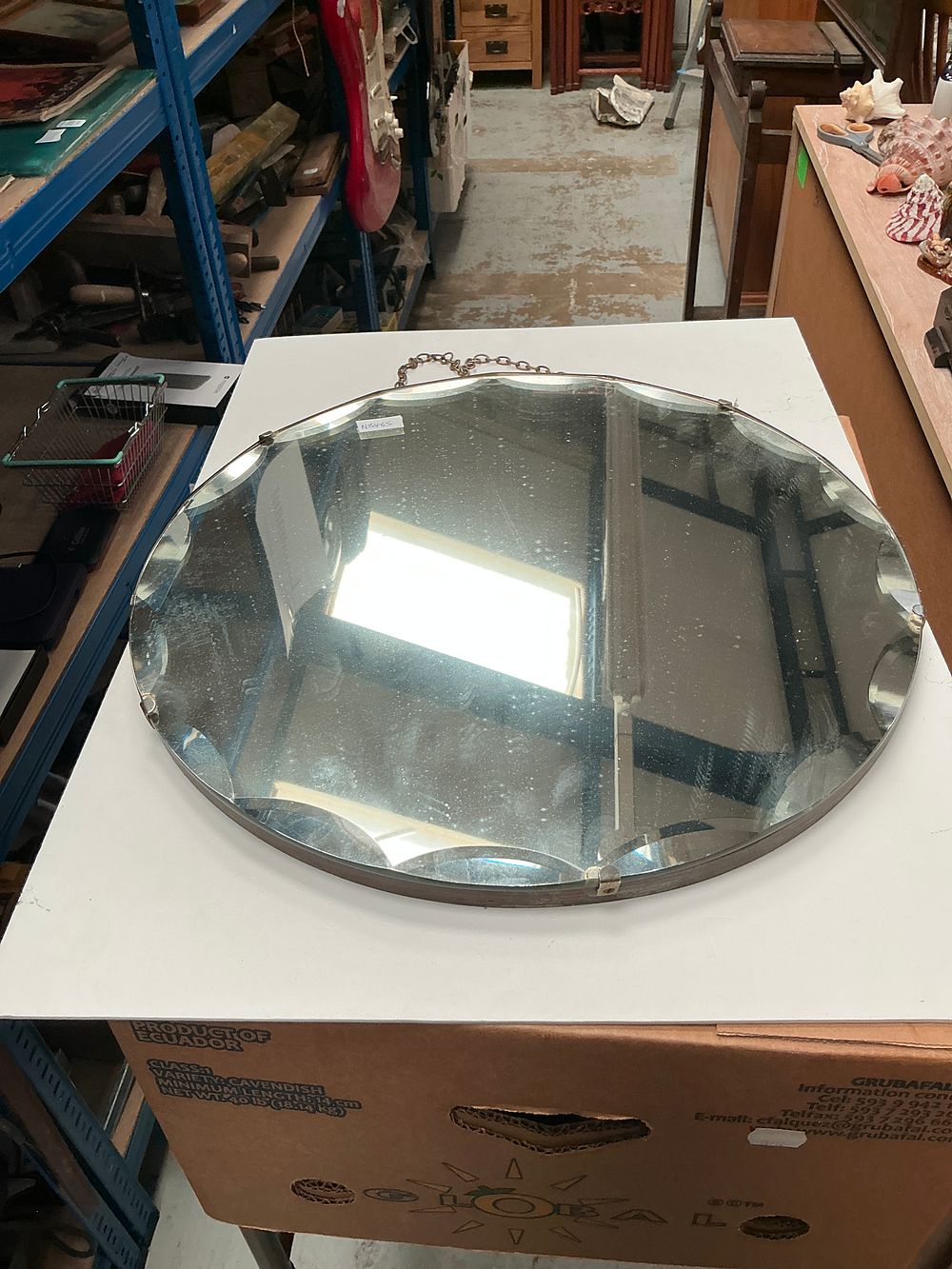 Lot 222: Two Oval Wall Mirrors comprising an Art Deco Style Frameless Example and a Carved Wood Framed Example