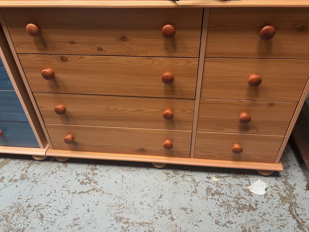 Lot 260: A Contemporary Wide Pine Chest of Eight Drawers on Bun Feet