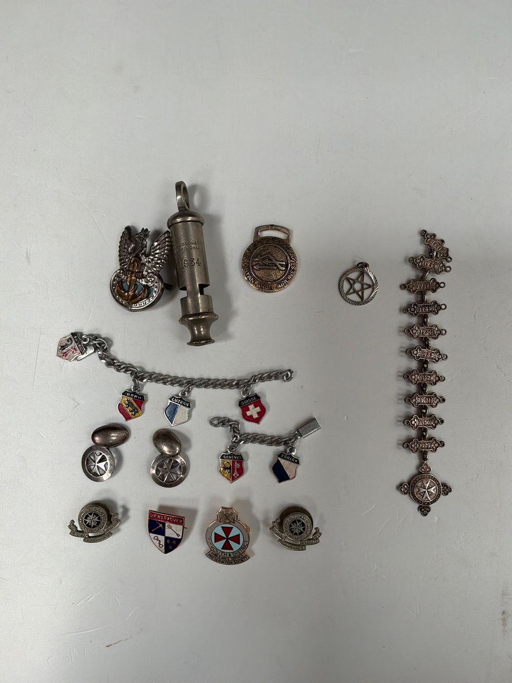 Lot 276: A Collection of Vintage Service Awards, Military Accessories, and Enamel Badges including St John Ambulance and J. Hudson and Co