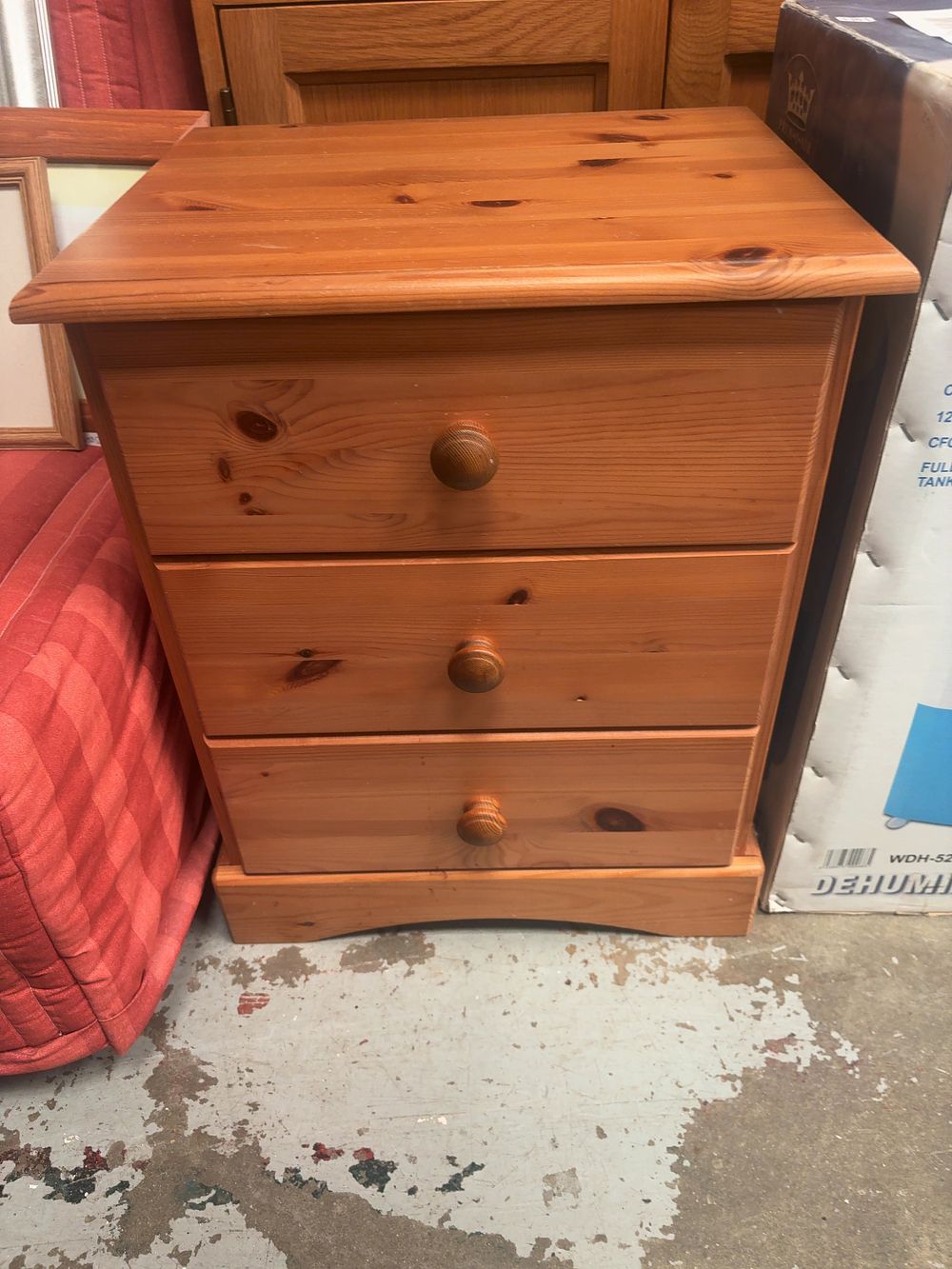 Lot 394: A modern pine three-drawer bedside chest of drawers