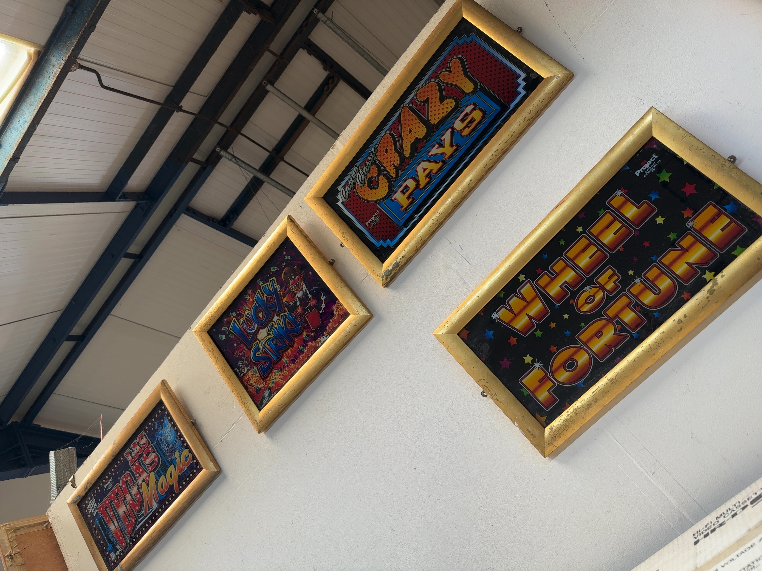 A Collection of Four Framed Project Coin Machines Ltd Fruit Machine Glass Marquees