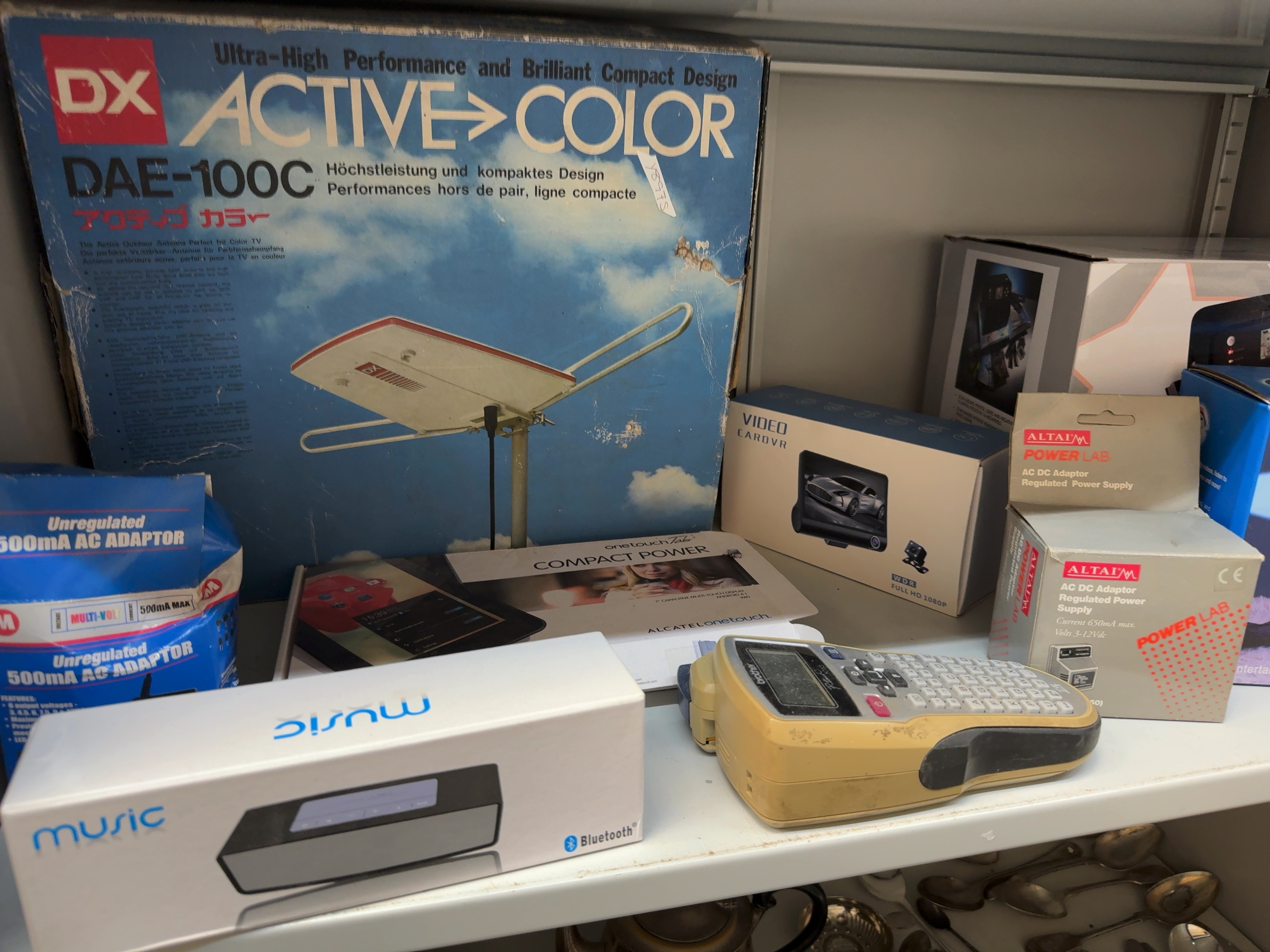 An Assortment of Consumer Electronics and Accessories Including a DX Antenna, Alcatel Tablet, and Brother Label Maker