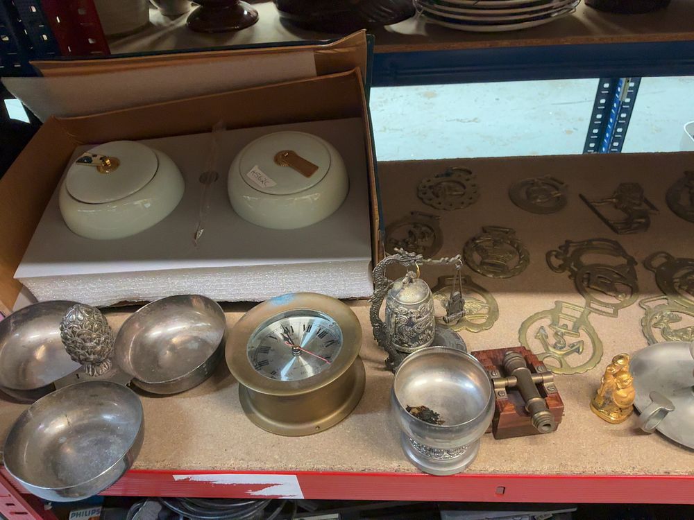 Lot 188: An Assortment of Decorative Objects and Metalware including a Circular Desk Clock, Horse Brasses, and Ceramic Lidded Jars