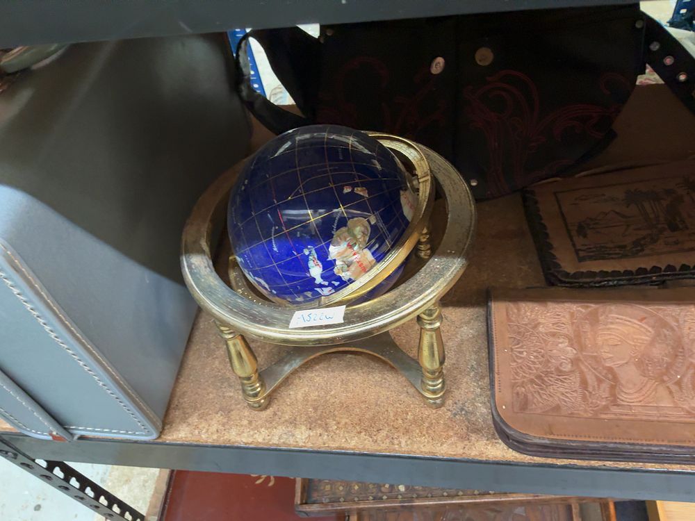 Lot 205: An Assortment of Decorative Home Items Including a Gemstone Globe, Tooled Leather Goods, and Various Serving Trays