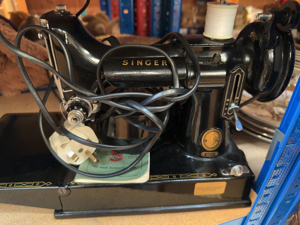 Lot 234: Vintage Singer 221K Sewing Machine and a Collection of Notions