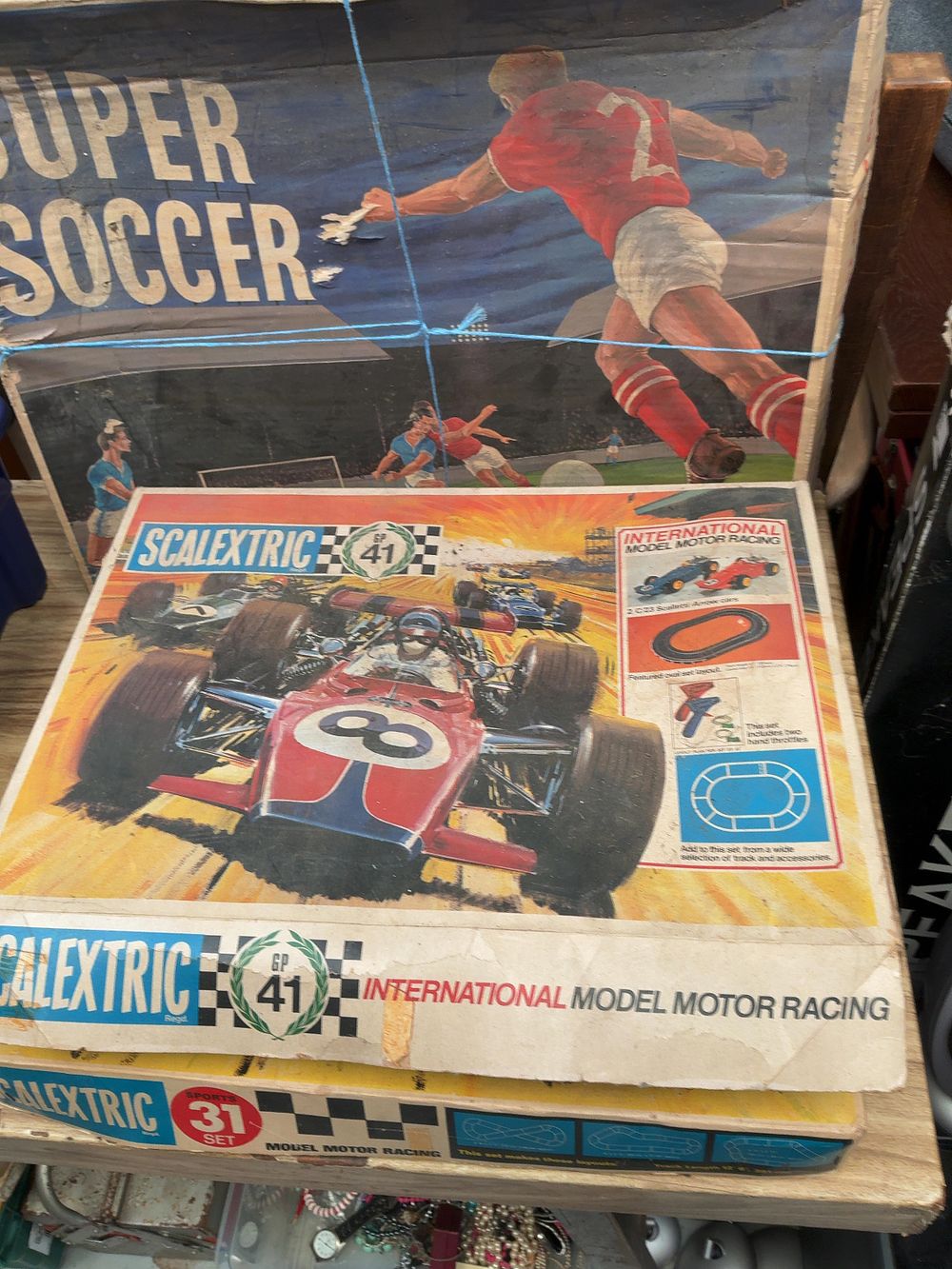 Lot 258: A Collection of Vintage Boxed Games and Toys including Scalextric GP 41, Scalextric Sports 31, and Super Soccer