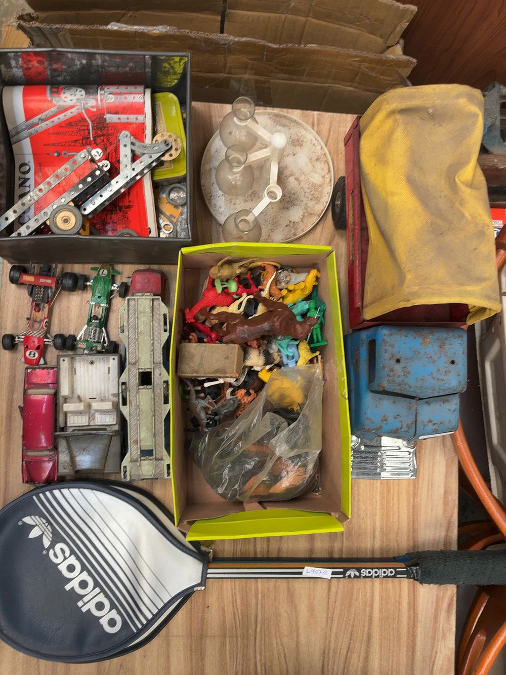 Lot 260: A Group of Vintage Toys and Sporting Goods Including Meccano, Die-cast Vehicles, a Transport Truck, and an Adidas Tennis Racquet