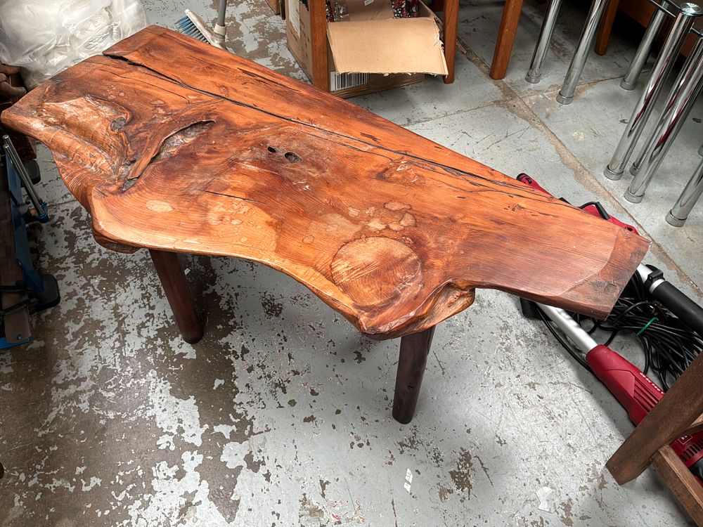 Lot 301: A mid-to-late 20th-century rustic live edge hardwood slab coffee table