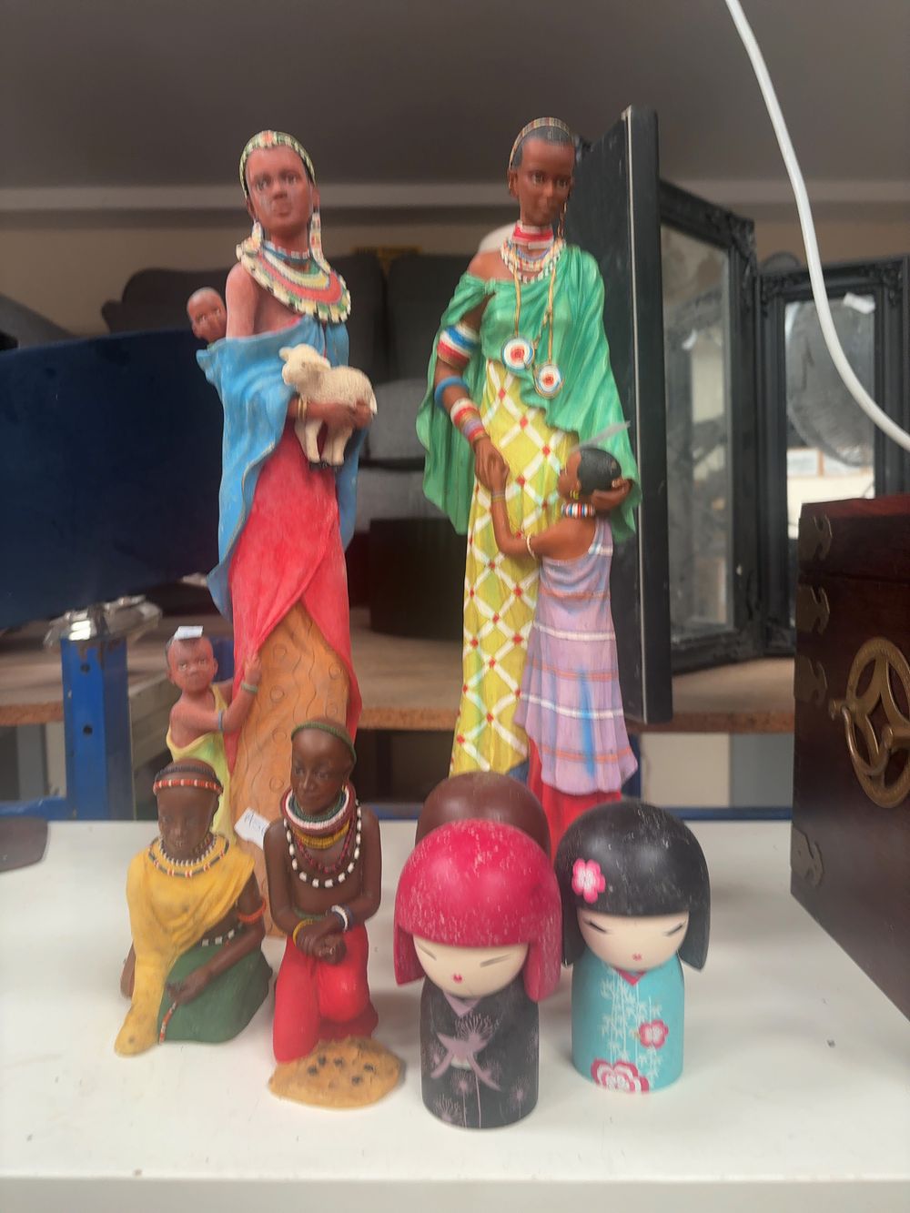 Lot 316: An Assortment of Decorative Figurines including Maasai-style and Kokeshi Subjects