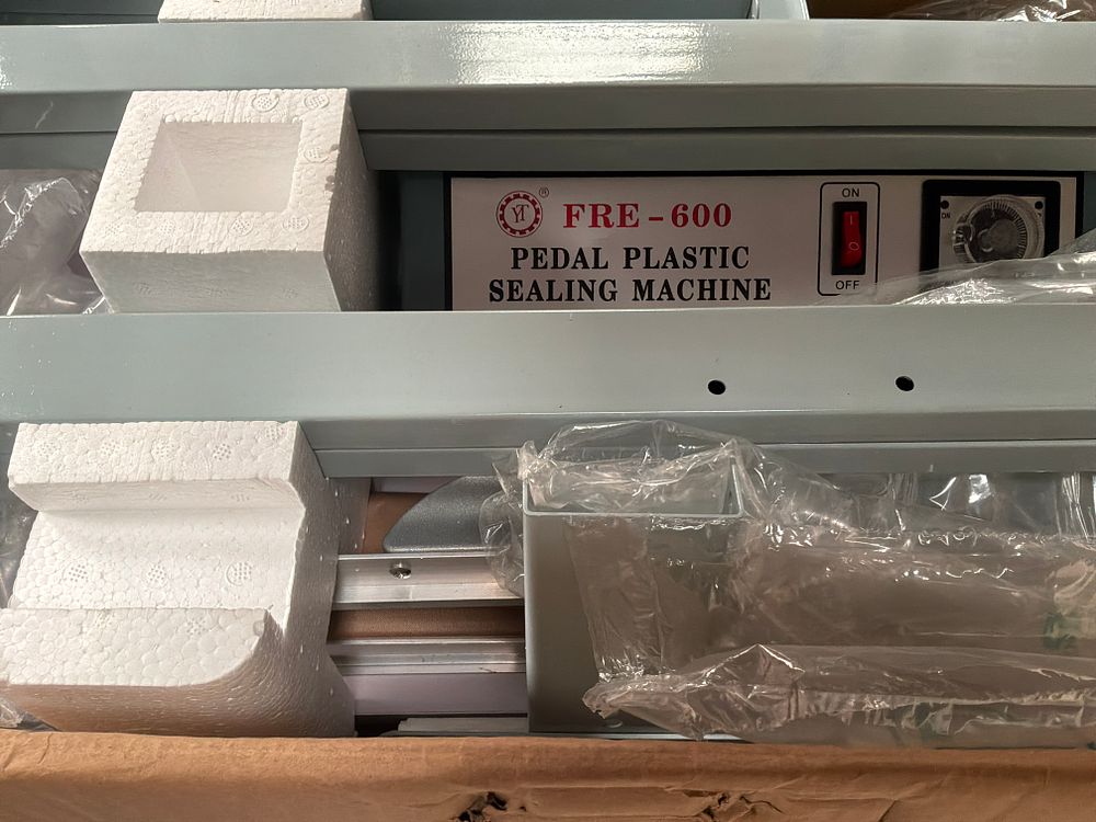 Lot 371: FRE-600 Pedal Plastic Sealing Machine with Plastic Film Roll