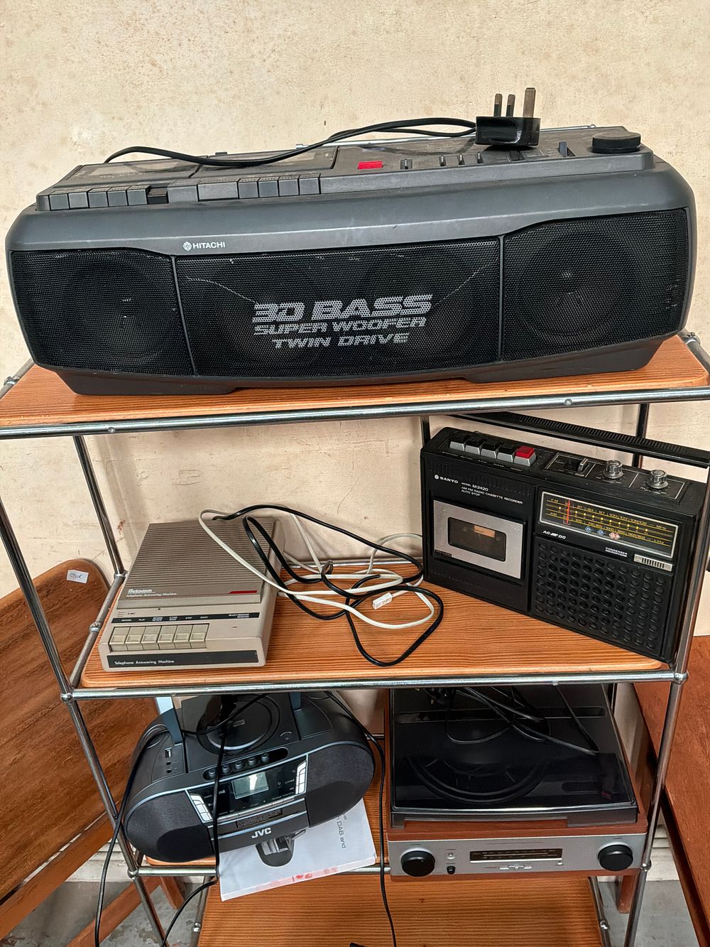 Lot 418: A Collection of Vintage and Modern Audio and Telecommunications Equipment Including Hitachi, Sanyo, and JVC