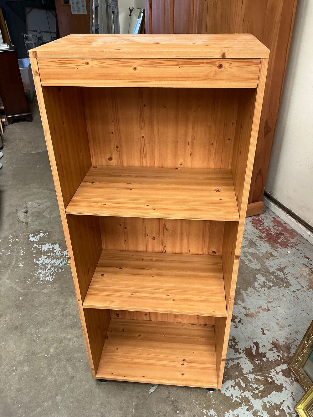 Lot 445: A Tall Knotty Pine Open Shelving Unit