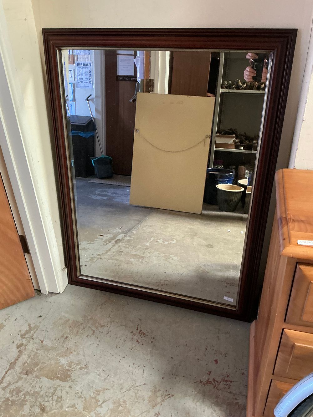 Lot 466: A large mahogany-finished rectangular wall mirror with a bevelled plate