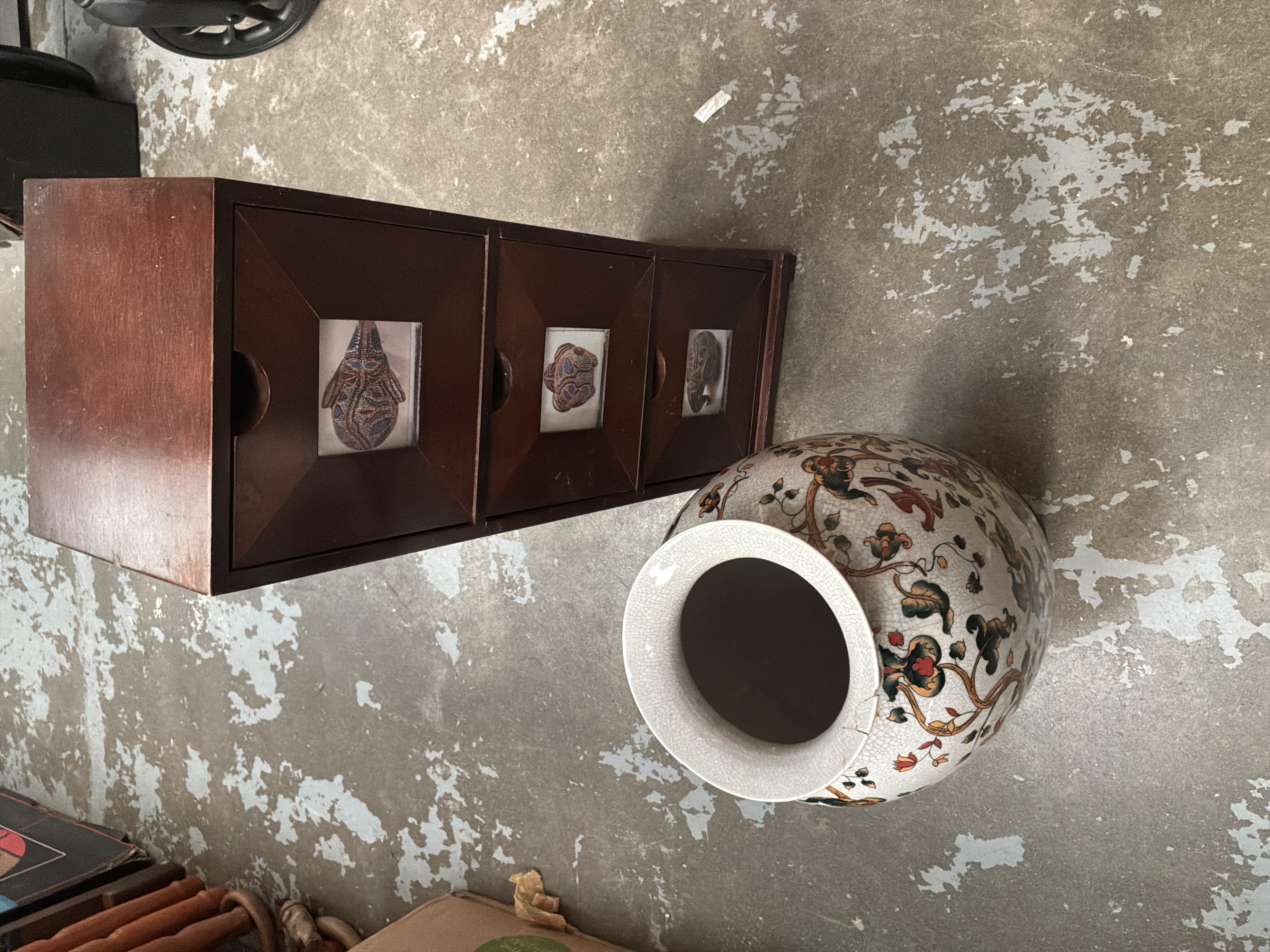 Two items comprising a small dark wood three-drawer chest and a large polychrome ceramic vase