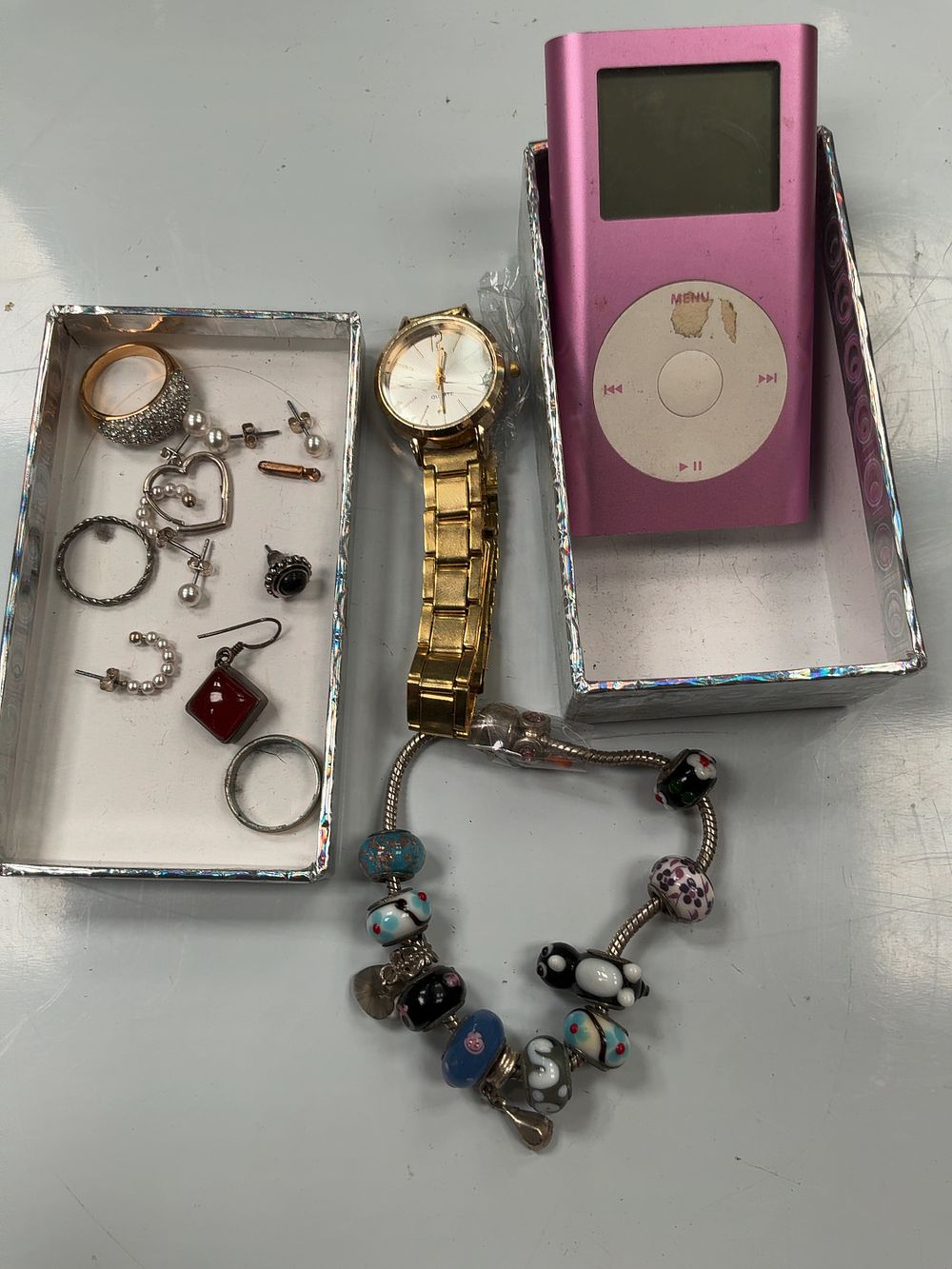 Lot 81: An Apple iPod Mini 1st Generation 4GB in Pink, a Gold-Tone Wristwatch, and an Assortment of Costume Jewellery