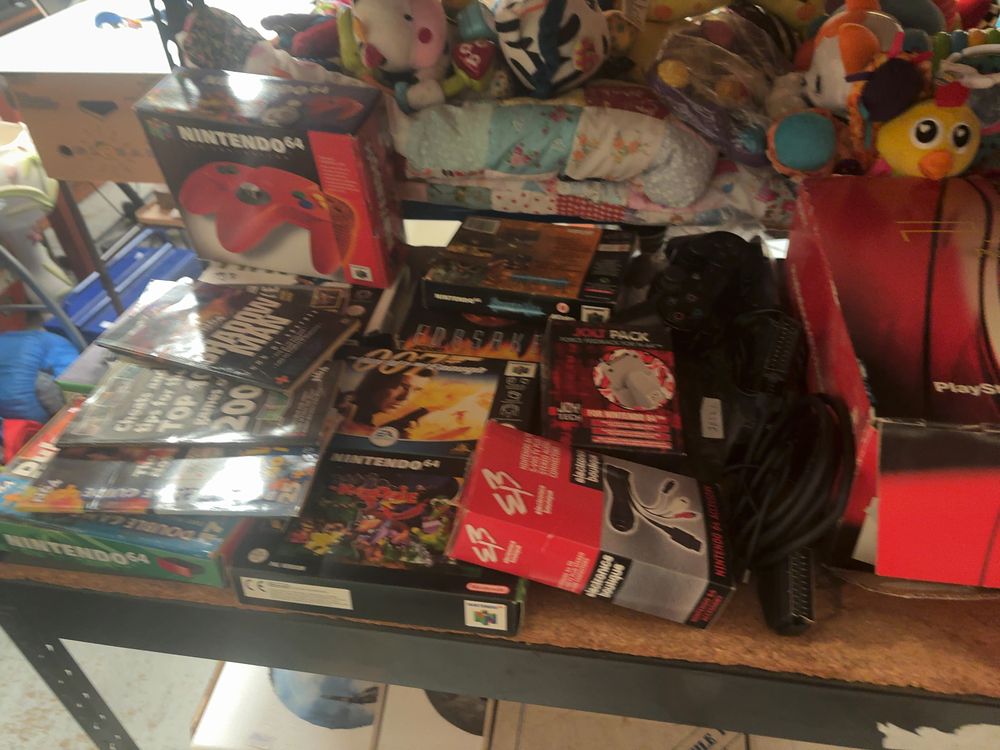 Lot 252: A Collection of Vintage Video Gaming Consoles, Boxed Nintendo 64 Games, Accessories, and Official PlayStation Magazines