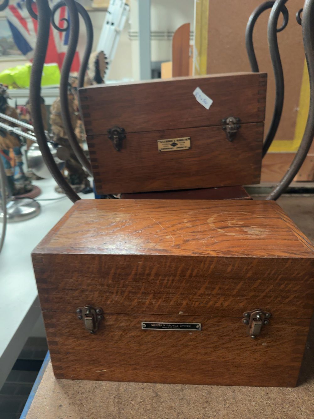 Lot 300: A Collection of Vintage Scientific Instrument Boxes by Griffin & George and Nivoc, a Monogrammed Leather Carrying Case, and a Wrought Iron Scrolled Stand